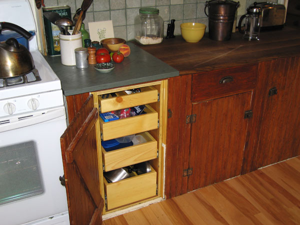 The low shelves are very easy to reach, and the outlets are moved forward. The slot under the counter is for cutting boards.